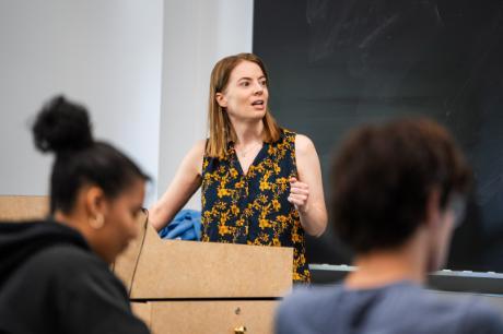 Kathleen Bachynski teaching in the classroom Fall 2025 with students in the forefront